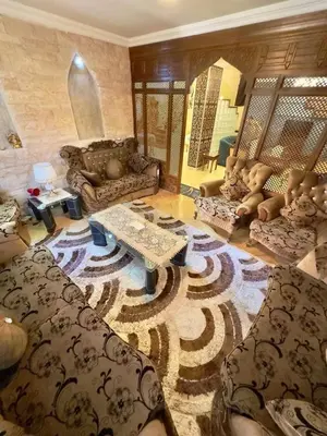 a living room with a couch and a table at olga 300 apertment in Ar Ramthā
