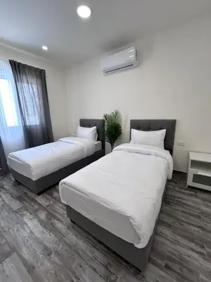 a bedroom with two beds and a window at The Greek Village - Milos By Seahorse in Sowayma
