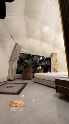 a bedroom with a bed in a tent at Hkaya Rum camp in Wadi Rum