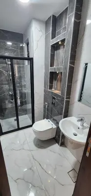 a bathroom with a sink and a toilet and a shower at شقة مفروشة بغرفتين نوم وصالة و حمامين in Amman