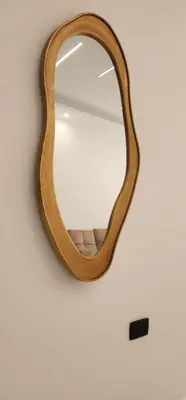 a wooden mirror hanging on a wall at شقة مفروشة بغرفتين نوم وصالة و حمامين in Amman