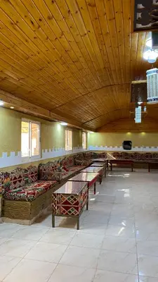 a large room with couches and tables in a building at Ali with the stars in Wadi Rum