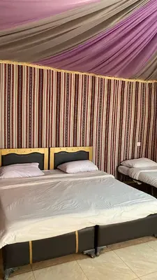 a room with two beds in a tent at Ali with the stars in Wadi Rum