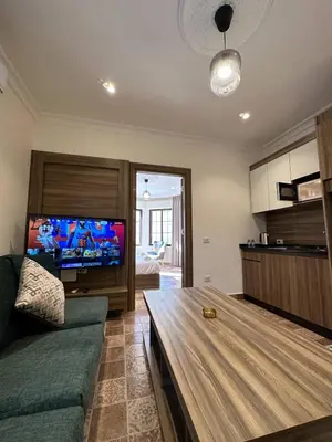 a living room with a couch and a flat screen tv at 1 Antica Jabalal-lwebdeh in Amman