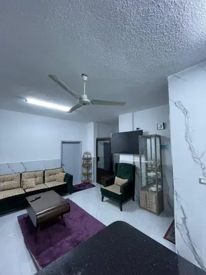 a living room with a couch and a ceiling fan at Jarash in Jerash