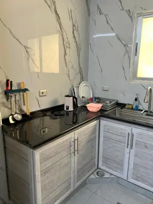 a kitchen with a sink and a counter top at Jarash in Jerash