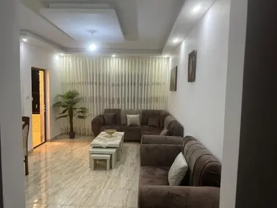 a living room with a couch and a table at Airport Road شارع المطار in Al Yādūdah