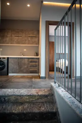 a kitchen with a staircase leading to a bedroom at Makanak Villas in Jerash