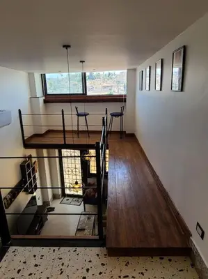 a room with a table and chairs in a house at Loft Apartment Jabal Amman A in Amman