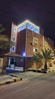 a building with lights on the side of it at Petra Friends House in Petra