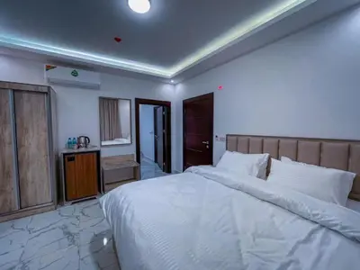 a bedroom with a large white bed in a room at Petra Friends House in Petra