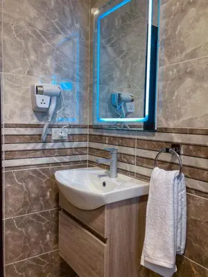 a bathroom with a sink and a mirror at Petra Friends House in Petra