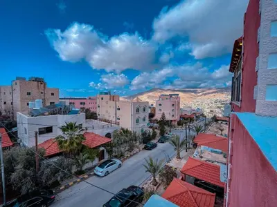 an aerial view of a city with buildings and cars at Petra Friends House in Petra