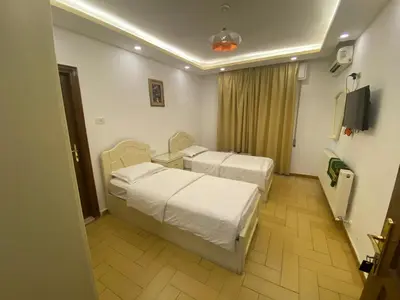 a hospital room with two beds and a television at فندق اربد بلازا in Irbid