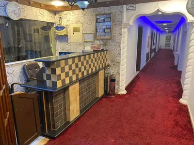 a hallway with a red carpet and a hallway with a corridorngthngthngthngth at فندق اربد بلازا in Irbid