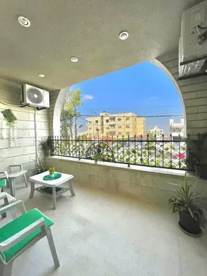 a balcony with a view of a city at Classy 3 Bedroom Apartment in Amman in Ţāb Kirā‘