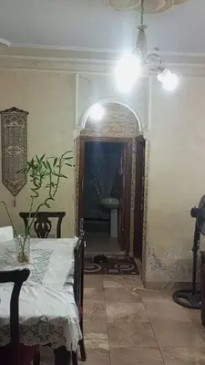 a dining room with a table and a ceiling fan at soon inn in Petra