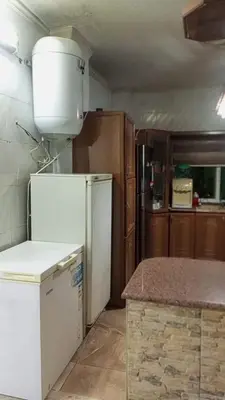 a kitchen with a white refrigerator and a counter at soon inn in Petra
