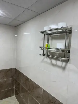 a bathroom with a shelf on the wall with towels at Magic mountains rum in Wadi Rum