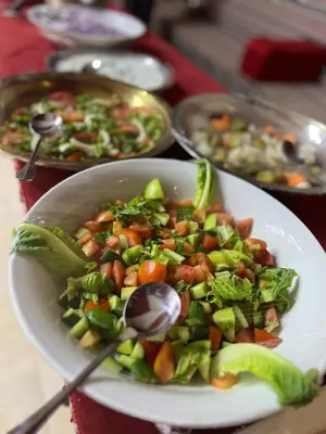 a bowl of food with a salad on a table at Magic mountains rum in Wadi Rum