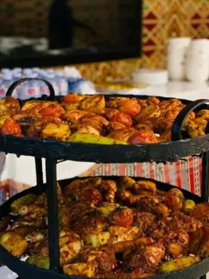 two tiers of food on a shelf with other foods at Wadi rum magical in Wadi Rum