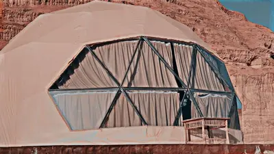 a dome tent with a bench inside of it at RADISSON lUXURY RUM CAMP in Wadi Rum