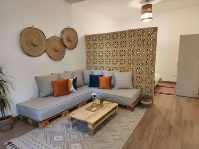 a living room with a couch and a coffee table at Goga Apartment in Jabal Amman near Rainbow Street in Ash Shumaysānī