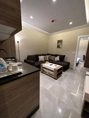 a living room with a couch and a table at Chic Apartments For Rent ave0-3 in Amman