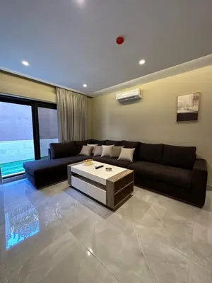 a living room with a couch and a coffee table at Chic Apartments For Rent ave0-5 in Amman