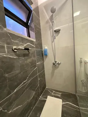 a bathroom with a shower and a toilet at Chic Apartments For Rent ave0-6 in Amman