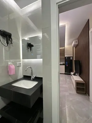 a bathroom with a sink and a large mirror at Chic Apartments For Rent ave0-6 in Amman