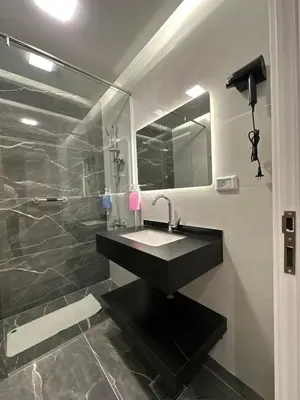 a bathroom with a black sink and a shower at Chic Apartments For Rent ave0-7 in Umm Uthainah