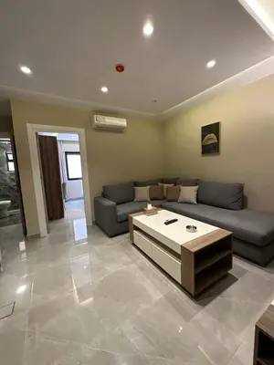 a living room with a couch and a coffee table at Chic Apartments For Rent ave0-8 in Umm Uthainah