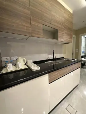 a kitchen with a sink and a counter top at Chic Apartments For Rent ave0-8 in Umm Uthainah