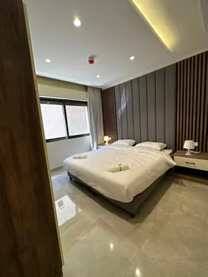 a bedroom with a large white bed in it at Chic Apartments For Rent ave0-8 in Umm Uthainah