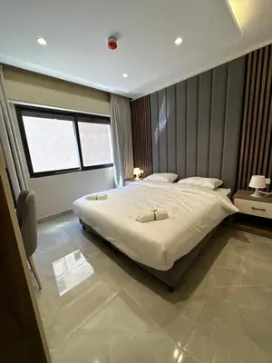 a bedroom with a large bed and a window at Chic Apartments For Rent ave0-8 in Umm Uthainah