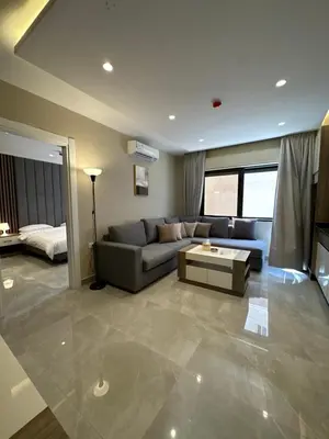 a living room with a couch and a table at Chic Apartments For Rent ave0-9 in Amman