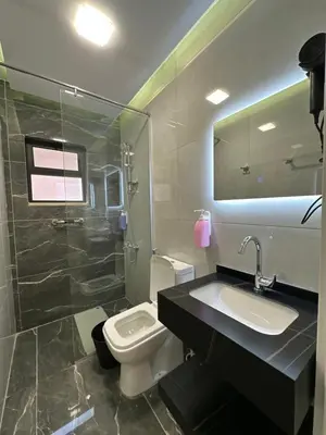a bathroom with a sink and a toilet and a shower at Chic Apartments For Rent ave0-9 in Amman
