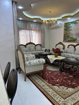 a living room with a couch and a table and chairs at شقة مفرشة في الرابية 3 غرف نوم in Amman