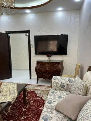 a living room with a couch and a flat screen tv at شقة مفرشة في الرابية 3 غرف نوم in Amman