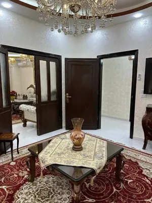 a living room with a table with a vase on it at شقة مفرشة في الرابية 3 غرف نوم in Amman