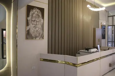 a lobby with a picture of a man with a beard at Azmal Hotel & Suites in Irbid