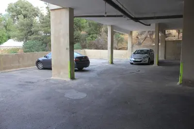 two cars are parked in a parking lot at Secured Compound Hill-view Terrace in Amman