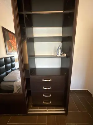 a dresser with a mirror in a bedroom at Secured Compound Hill-view Terrace in Amman