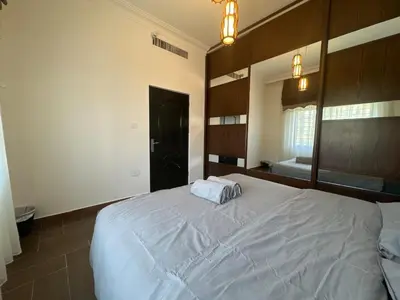 a bedroom with a large bed with a large mirror at Secured Compound Hill-view Terrace in Amman