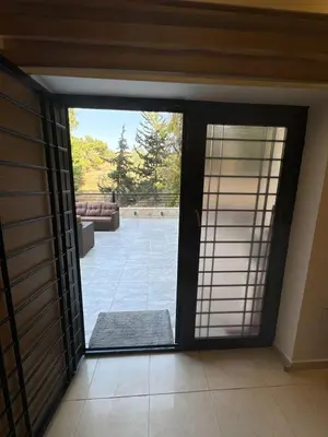 a sliding glass door with a view of a patio at Secured Compound Hill-view Terrace in Amman