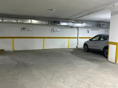 a parking garage with a car parked in it at 2 En-suite Rooms, Central & Garden Terrace in Amman