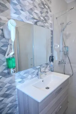 a bathroom with a sink and a mirror at Luxury Apt with Private Beach In Ayla in Aqaba