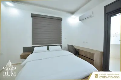 a bedroom with two beds and a window at رمّ للأجنحة Rum Royal Suites in Irbid