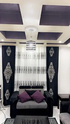 a living room with a couch in front of a window at شقةارضية فاخرة مفروشة عمان ضاحية الرشيد in Ţāb Kirā‘
